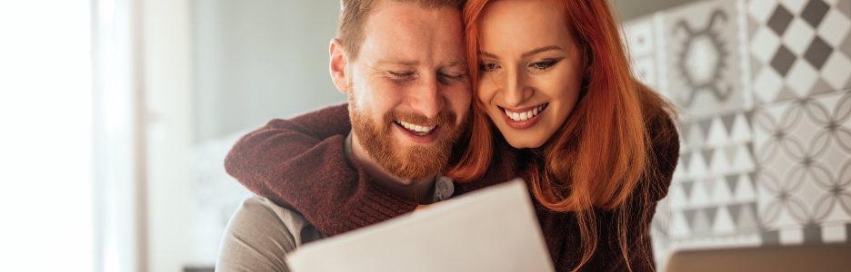 Una imagen de una pareja mirando los resultados de su declaración de la renta