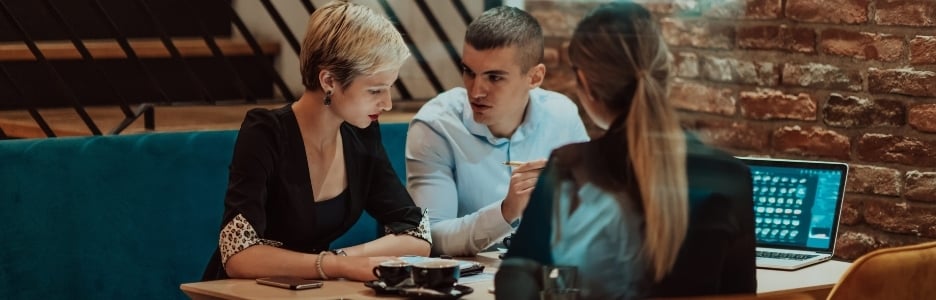Imagen de empresarios felices sonriendo con entusiasmo durante una reunión en una cafetería. Un grupo de profesionales de negocios exitosos trabajando en equipo en un entorno laboral multicultural