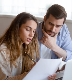Imagen de una pareja haciendo contabilidad en un papel