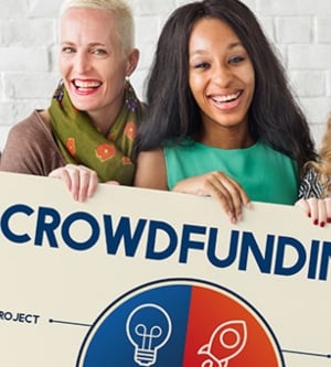 Imagen de un grupo de personas con un cartel de crowdfunding