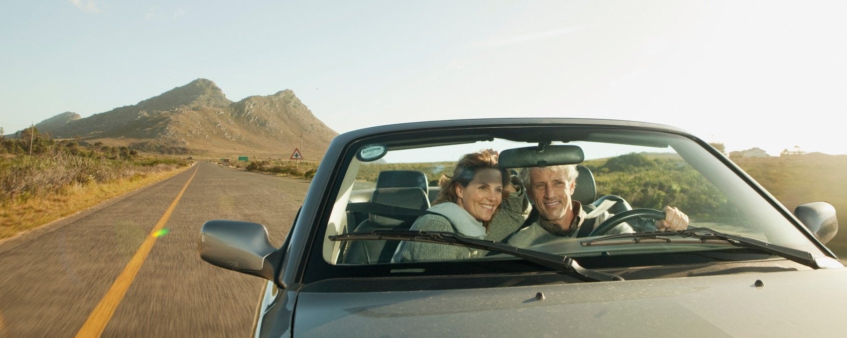 Image of a couple on a roadtrip in their car