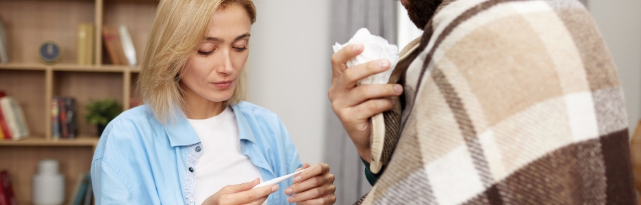 Image of woman measuring husband temperature young woman taking care of ill man