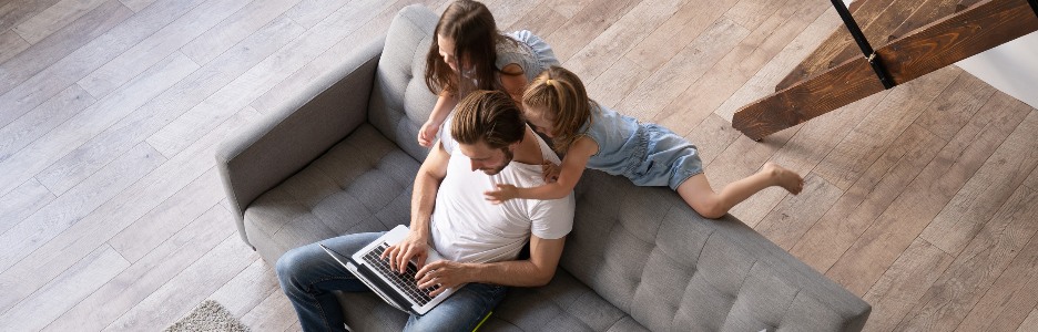 Image of Caucasian man working from home with children, reviewing documents