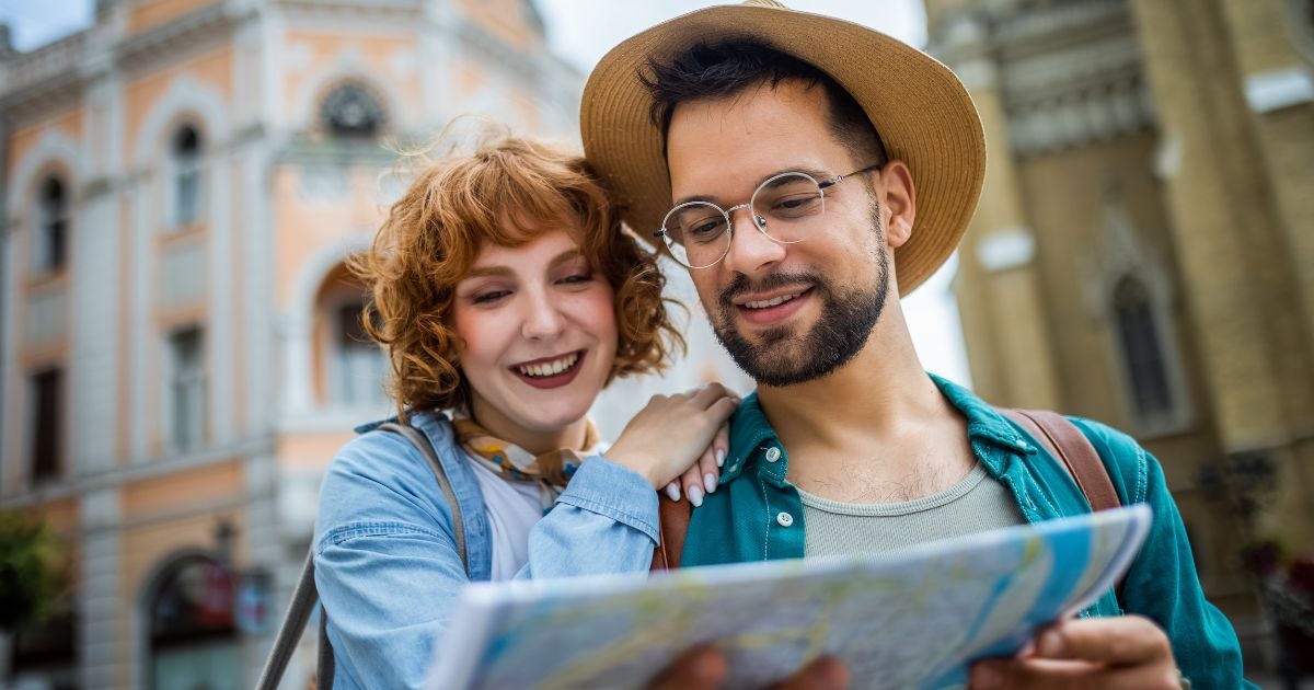 Image of young couple using a map to explore the new city on their vacation