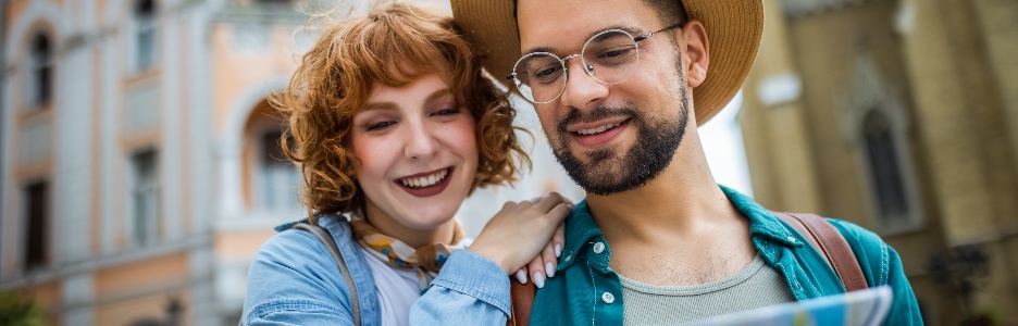 Image of a young couple using a map to explore the new city on their vacation